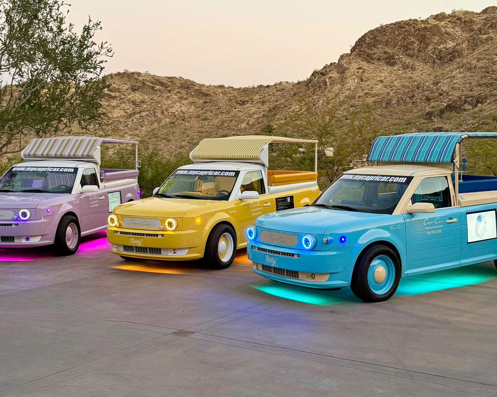 Lavender, yellow and blue Capri Cars against the Scottsdale foothills
