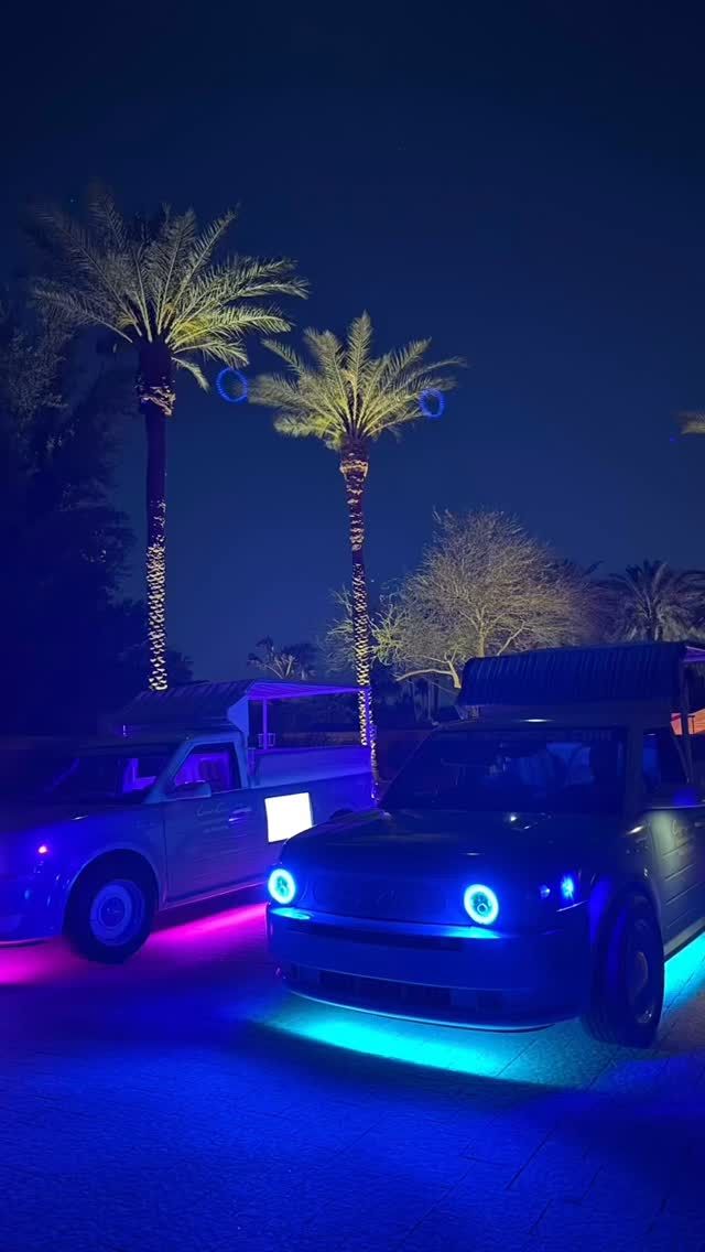Capri Cars glowing under palm trees