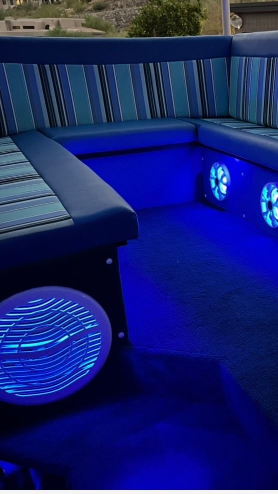 Striped bench seating lit in blue with glowing speakers