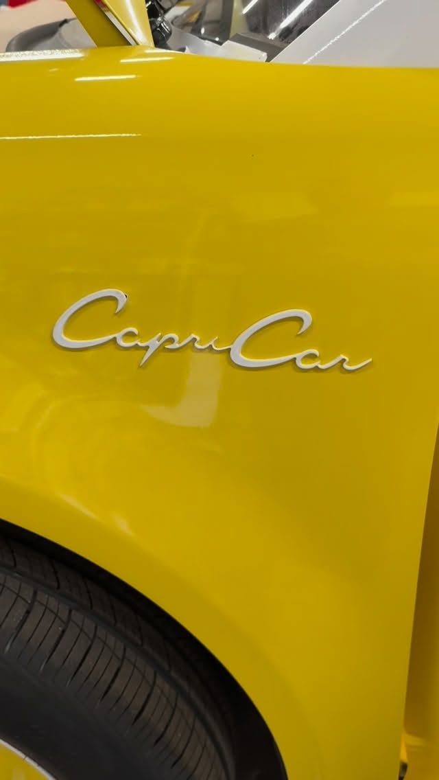Chrome Capri Car script badge on yellow paint